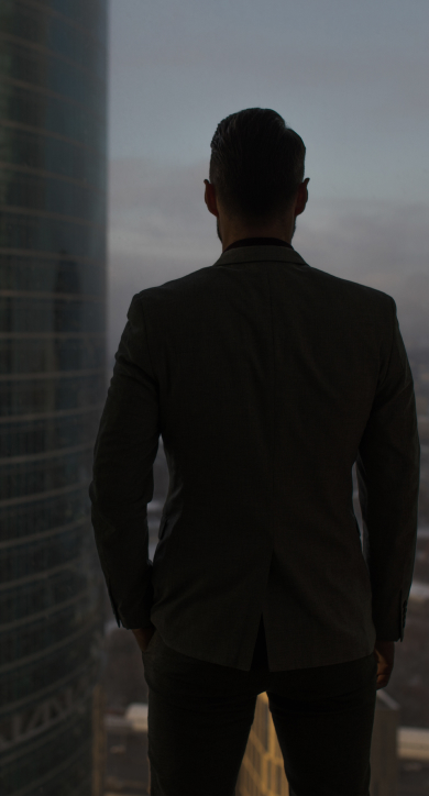 Man looking out of a skyscraper window